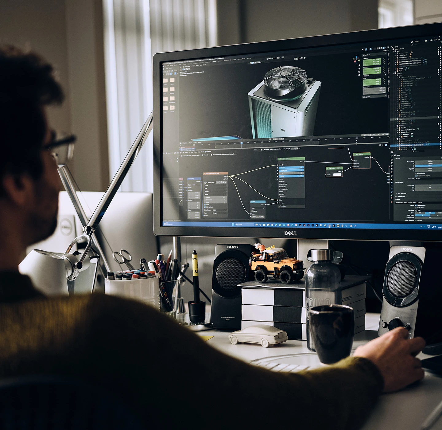 Designer sitting in fron of a screen. Creating design for heat pumps